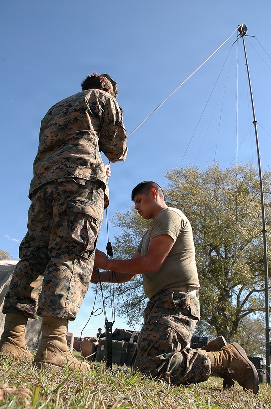 Marines from Marine Expeditionary Unit Service Support Group 24 erect a communications tower on Oct. 25 during a three-day command post exercise. The Marines and sailors of the 24th MEU command element are training to coordinate and operate a forward command operations center.