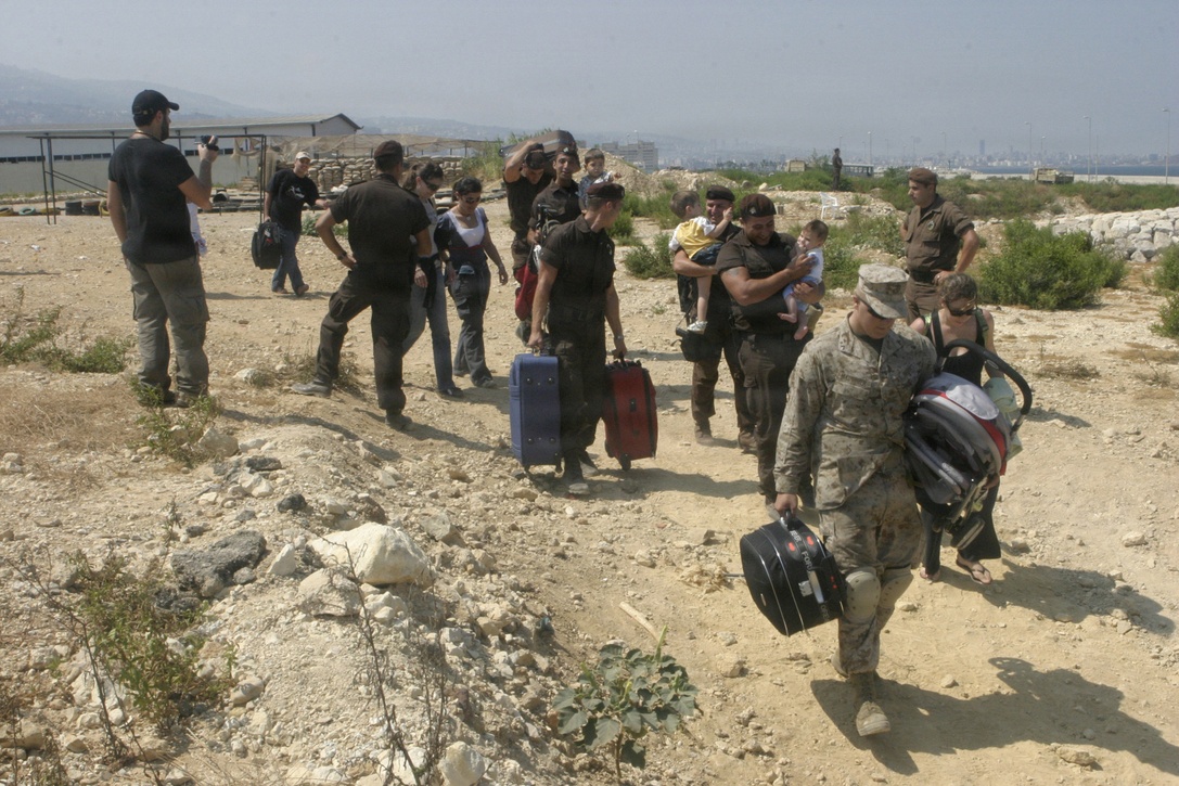 A U.S. Marine from the 24th Marine Expeditionary Unit assists American citizens as they depart Beirut, Lebanon, July 22, 2006. At the request of the U.S. Ambassador to Lebanon and at the direction of the Secretary of Defense, the United States Central Command and elements of Task Force 59 are assisting with the departure of U.S. citizens from Lebanon.  (U.S. Marine Corps photo by Lance Cpl. Andrew J. Carlson) (Released)::n::::n::