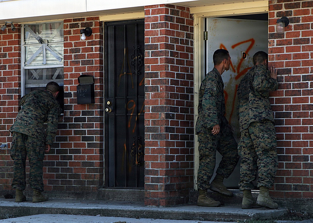 NEW ORLEANS (Sep. 8, 2005) - Infantrymen from Bravo Company, 1st Battalion, 8th Marines, conduct door to door searches in an effort to rescue those stranded by Hurricane Katrina. The infantrymen disembarked from amphibious assault vehicles in the few dry sections of Orleans and St. Bernard Parishes to conduct search and rescue. In areas submerged in flood water, AAVs from 4th Amphibious Assault Battalion, a reserve unit headquartered in Jacksonville, Fla., maneuvered to second story windows and doors to look for survivors.