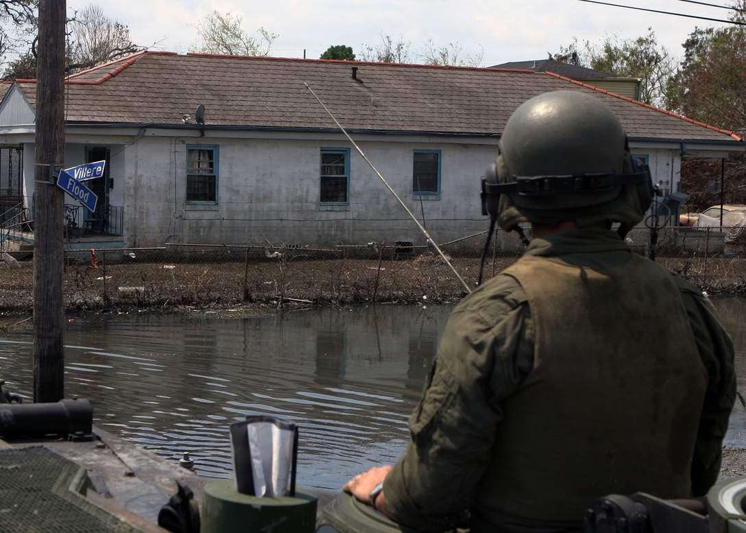 NEW ORLEANS (Sep. 9, 2005) - A Marine with 4th Amphibious Assault Battalion surveys the damage during a search and rescue operation in New Orleans' Ninth Ward District.::n::