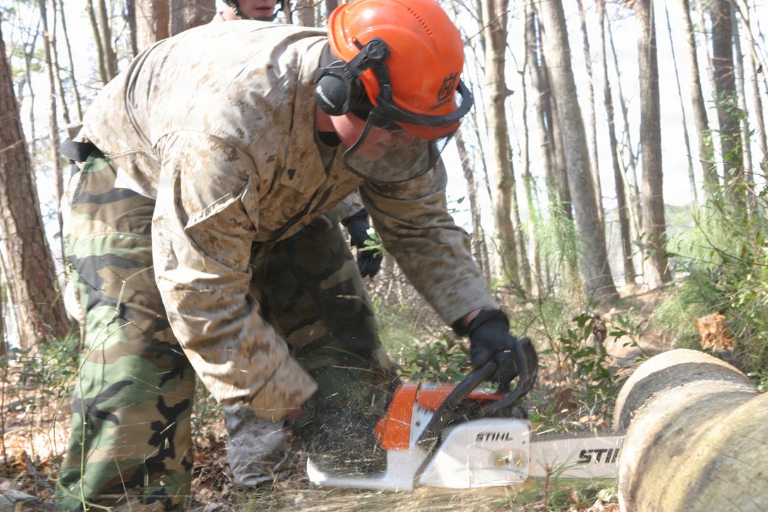 Cpl Justin Muir, 21, from Marine Expeditionary Unit Service Support Group-24 of the 24th Marine Expeditionary Unit, cuts down a tree with a chainsaw at Redman Park Va. Beach for a civil affairs mission on March 3, 2006. MSSG-24 is the support element of the 24th Marine Expeditionary Unit, which is currently conducting Training in Urban Environment Exercise. (U.S. Marine Corps Photo by Lance Corporal Joshua Lujan)::n::::n::  ::n::