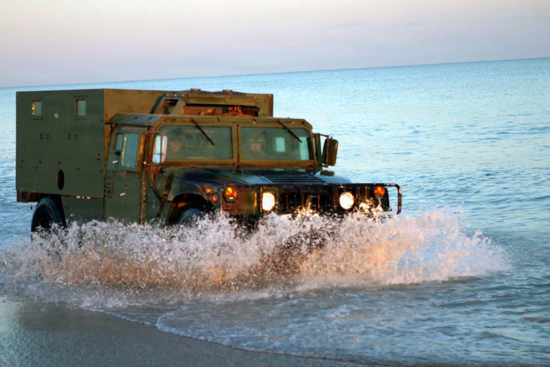 Marines drive their Humvee through the surf at Onslow Beach aboard Marine Corps Base Camp Lejeune, N.C., during driver?s improvement training held during Expeditionary Strike Group/MEU Integration Training Feb. 9.  The training was held to help drivers?s familiarize themselves with how the vehicle handles when driving through water.