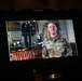 A SmallRig/Atomos external monitor displays a U.S. Army soldier named Miller being filmed in what appears to be an official interview or video production setting. The soldier is wearing OCP (Operational Camouflage Pattern) uniform with a U.S. Army tape and a name tape reading 'MILLER', and rank insignia visible on the chest. The background on the monitor shows a formal office or display room with framed artwork, military memorabilia, and wooden furniture.