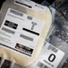 The image shows medical training supplies, specifically simulated freeze-dried plasma bags used for training purposes only. The primary bag is labeled with multiple warnings indicating it is 'NOT FOR HUMAN USE' and 'NOT FOR TRANSFUSION,' and contains non-biohazardous material. A secondary bag visible on the right is labeled 'O POOLED Rh,' suggesting it simulates Type O Rh blood product for training scenarios.