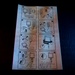 The image shows a printed instruction sheet with 8 numbered sequential steps for assembling or operating a medical or technical device, likely an IV infusion set or similar fluid delivery system. The sheet contains black-and-white line drawings arranged in a 2x4 grid layout. The paper is photographed on a dark surface under mixed lighting conditions.