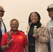 Four adults are posing together while holding bottles of 'Double Time Sports Drink.' Two of the individuals are wearing branded Double Time Sports Drink apparel, suggesting they may be associated with the brand. The group appears to be at a promotional or product showcase event.