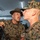 Lima Company Senior Drill Instructor Inspection A U.S. Marine drill instructor wearing a campaign cover (drill sergeant hat) is shouting directly at a recruit in MARPAT camouflage uniform during what appears to be a training or processing event. The drill instructor is in close proximity to the recruit's face in a classic military instruction/discipline posture. The setting appears to be an indoor facility with other personnel visible in the background.