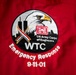 The image shows an embroidered patch on a red jacket or garment commemorating the US Army Corps of Engineers' emergency response to the World Trade Center on September 11, 2001. The circular patch features a bald eagle, the Twin Towers silhouette, a patriotic ribbon, and the USACE castle logo. Text on the patch reads 'WTC Emergency Response 9-11-01'.
