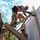A group of military personnel in camouflage uniforms are working on a wooden structure, likely during a training exercise or disaster response operation. They are wearing high-visibility orange safety vests and red helmets while handling lumber on what appears to be a partially constructed or damaged wooden frame. The low-angle shot emphasizes the height and physical nature of the work being performed.