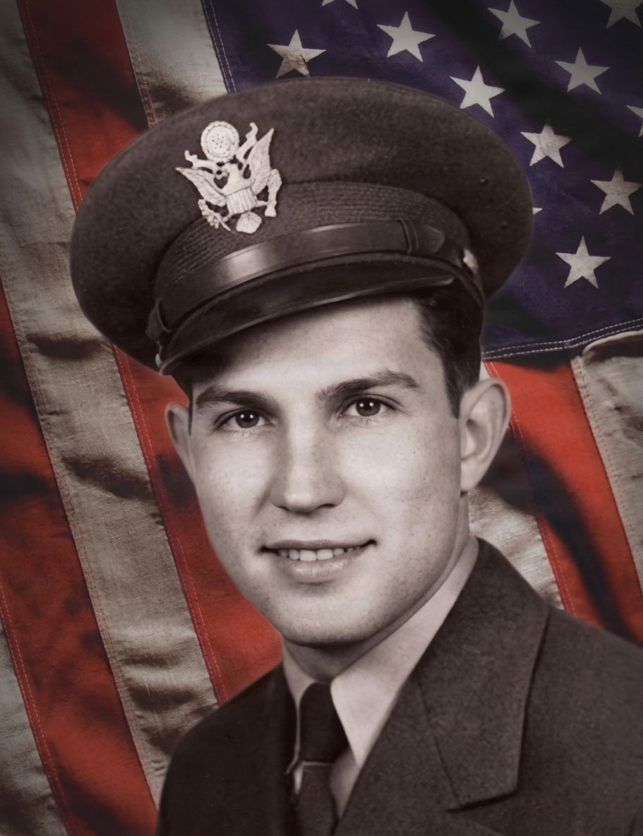 A black-and-white formal military portrait photograph of a young male serviceman, composited against a colorized American flag background. The subject wears a U.S. military service cap with an eagle insignia and a dark uniform with tie. The image appears to be a mid-20th century official or semi-official military portrait, likely from the World War II or Korean War era.