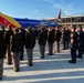 A formal ceremonial gathering is taking place on an airport tarmac in front of Southwest Airlines aircraft. Multiple uniformed personnel — including what appear to be law enforcement officers, military members, and security staff — are assembled in organized formations. The scene suggests a dignitary arrival, fallen officer tribute, or official honors ceremony.