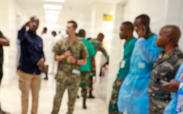 The image shows a group of military and medical personnel gathered in what appears to be a hospital corridor. In the foreground, a soldier's arm is clearly visible displaying patches reading 'Special Forces,' 'Ranger,' 'SETAF,' and 'Africa.' The scene suggests a military medical exchange, training visit, or joint operation between U.S. Special Forces and local military/medical staff.