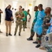 The image shows a group of military and medical personnel gathered in what appears to be a hospital corridor. In the foreground, a soldier's arm is clearly visible displaying patches reading 'Special Forces,' 'Ranger,' 'SETAF,' and 'Africa.' The scene suggests a military medical exchange, training visit, or joint operation between U.S. Special Forces and local military/medical staff.