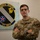 A U.S. Air Force service member named Bianchini stands with arms crossed in front of the 371st Special Operations Combat Training Squadron (371 SOCTS) emblem. The individual wears OCP (Operational Camouflage Pattern) uniform with visible rank insignia of Senior Airman and a name tape reading 'BIANCHINI'. The squadron emblem behind them displays the Latin motto 'Scientia Invictus' meaning 'Knowledge Unconquered'.
