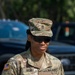 A U.S. Army soldier wearing Operational Camouflage Pattern (OCP) uniform is photographed outdoors. The soldier, identified by name tape as 'RICHEY,' holds the rank of Sergeant Major as indicated by insignia on the patrol cap and chest. The soldier is wearing ballistic/protective eyewear and appears to be reviewing a document.