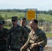 A group of U.S. Army soldiers in MultiCam/OCP camouflage uniforms are gathered outdoors near a military range area. The foreground soldier displays an EOD (Explosive Ordnance Disposal) tab patch on his uniform. The setting appears to be a training range facility, indicated by a yellow 'Range 4' sign visible in the background.