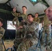 A group of U.S. Army soldiers in MultiCam/OCP camouflage uniforms are engaged in what appears to be a tactical briefing or discussion inside a military field tent. Several soldiers are gesturing and speaking, suggesting an active planning or after-action review session. Visible unit patches indicate affiliation with the 1st Cavalry Division and other Army units.