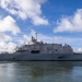 A U.S. Navy Littoral Combat Ship bearing hull number 19 is photographed underway or maneuvering in calm harbor waters. The vessel displays the characteristic flat, angular design of the Freedom-class LCS with a low freeboard and prominent superstructure. Personnel are visible on deck, suggesting the ship is in an active operational status.