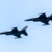 Two F-16 Fighting Falcon jet fighters fly in close formation against a pale blue sky. Both aircraft bear the tail code 'AC' and serial numbers 226 and 236, indicating they belong to the New Jersey Air National Guard's 177th Fighter Wing based at Atlantic City (AC). The aircraft are equipped with visible air-to-air missiles and external fuel tanks or munitions pods.