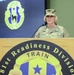 A U.S. Army Major General is speaking at a podium for the 81st Readiness Division. The officer, identified by the name tape as 'DAYGRESHAM' and wearing two-star rank insignia, is dressed in Army Combat Uniform (ACU) with OCP (Operational Camouflage Pattern). The setting appears to be an official military briefing or ceremony.