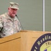 A U.S. Army Lieutenant General named Harter is speaking at a podium during an official military event. He is wearing the Army Combat Uniform (ACU) in MultiCam pattern with three-star rank insignia visible on both his cap and chest. The podium bears a seal referencing 'Readiness' and 'TRAIN,' suggesting a training or readiness-focused military ceremony or briefing.