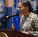 A U.S. Air Force officer, identifiable by the 'U.S. AIR FORCE' tape and 'Air National Guard' shoulder patch, is speaking at a wooden podium equipped with a gooseneck microphone. The officer's name tape reads 'MAYS' and a single star insignia is visible on the uniform, indicating the rank of Brigadier General. The setting appears to be an official military ceremony with flags visible in the background.