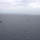 Ships sail in formation during Phoenix Express 2026 An aerial photograph showing a formation of multiple naval vessels underway on an overcast, grey sea. At least five ships are visible spread across the frame, suggesting a multi-ship naval exercise or transit operation. Visibility is reduced due to hazy, overcast weather conditions.