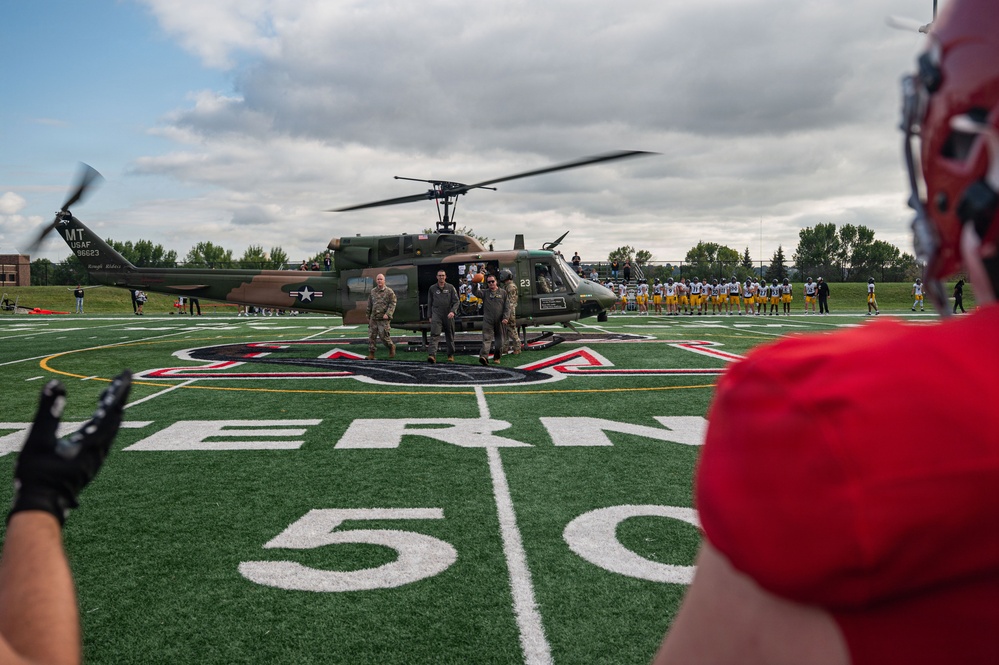 5th Bomb Wing Leadership delivers the game ball for the Prairie Warrior Bowl Military Appreciation game