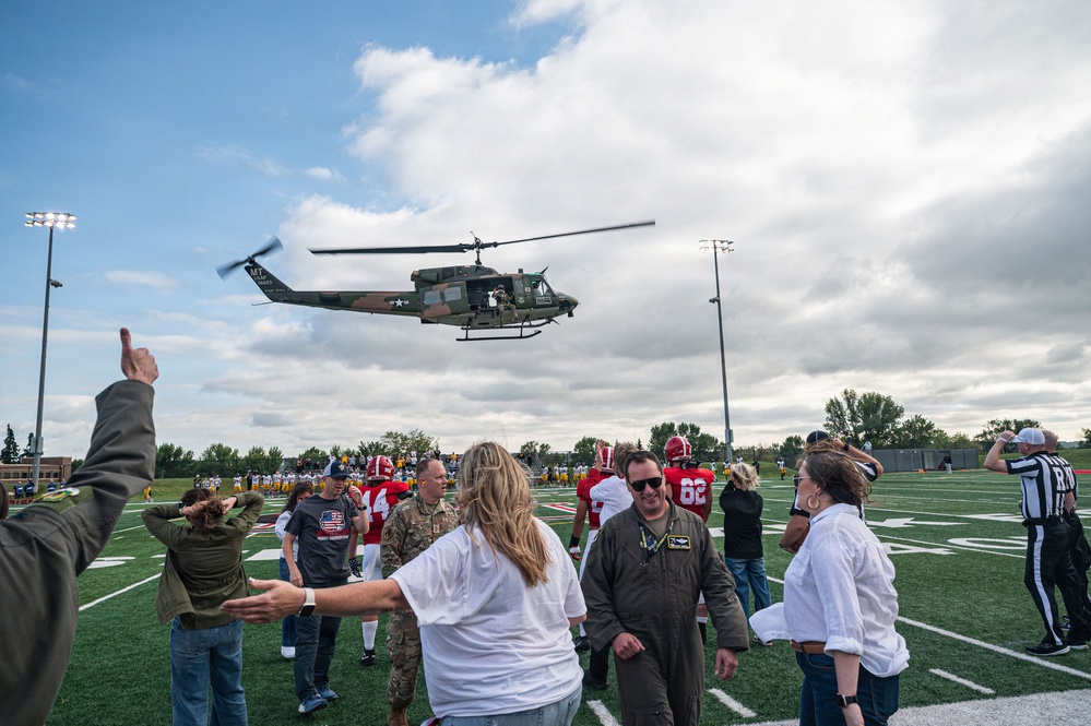 5th Bomb Wing Leadership delivers the game ball for the Prairie Warrior Bowl Military Appreciation game