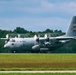 A U.S. Air Force C-130 Hercules military transport aircraft is captured during takeoff or landing roll on a runway. The aircraft bears tail number 23023 and AFRC (Air Force Reserve Command) markings, along with an American flag and what appears to be an Ohio state flag on the tail. The image uses a panning technique, creating motion blur in the background while keeping the aircraft relatively sharp.