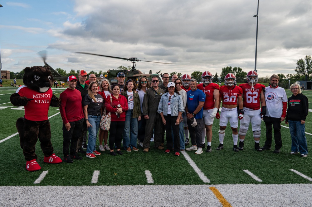 5th Bomb Wing Leadership delivers the game ball for the Prairie Warrior Bowl Military Appreciation game