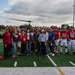 5th Bomb Wing Leadership delivers the game ball for the Prairie Warrior Bowl Military Appreciation game