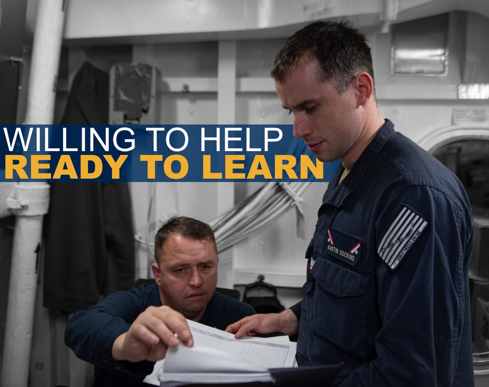 A promotional military image showing two personnel in dark blue uniforms reviewing documents together aboard what appears to be a naval vessel. The standing individual is identified by a name tag as 'Austin Dockins' and wears a US flag patch on his sleeve. The image includes overlaid text reading 'WILLING TO HELP / READY TO LEARN,' suggesting a recruitment or training context.
