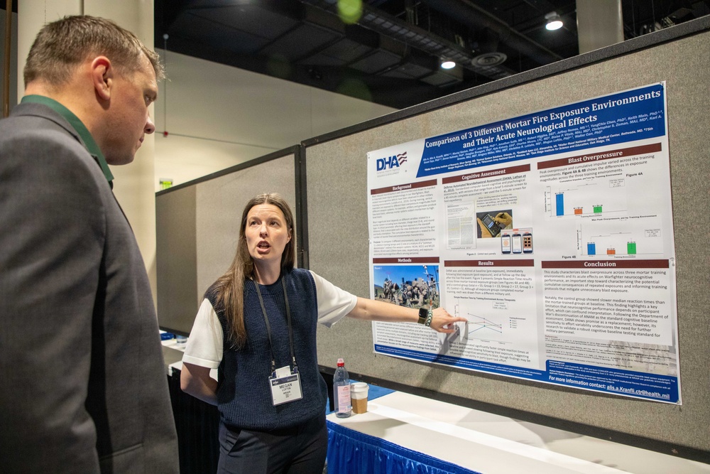 A woman named Megan (visible on her name badge) is presenting a scientific research poster at what appears to be an academic or military health conference. The poster, affiliated with the Defense Health Agency (DHA), is titled 'Comparison of 3 Different Mortar Fire Exposure Environments and Their Acute Neurological Effects.' She is pointing at the poster while explaining its contents to a man in a gray suit.
