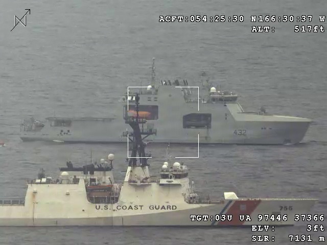 An aerial surveillance image captured from an aircraft at 517 feet altitude showing two large vessels at sea. The foreground vessel is a U.S. Coast Guard cutter (hull number 755), while the background vessel bears hull number 432 and appears to be a foreign naval or patrol ship. A third smaller vessel is visible in the far background to the left.