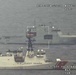 An aerial surveillance image captured from an aircraft at 517 feet altitude showing two large vessels at sea. The foreground vessel is a U.S. Coast Guard cutter (hull number 755), while the background vessel bears hull number 432 and appears to be a foreign naval or patrol ship. A third smaller vessel is visible in the far background to the left.