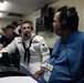 A U.S. Navy sailor in dress white uniform is being interviewed or conversing with a broadcaster wearing a blue AZPreps365 polo shirt, both wearing headsets. The setting appears to be a press box or broadcast booth at a state championship sporting event. Additional personnel are visible working in the background.