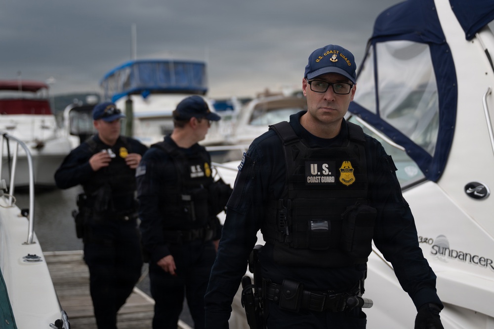 U.S. Coast Guard personnel conduct maritime security patrol at marina