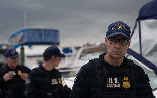 U.S. Coast Guard personnel conduct maritime security patrol at marina