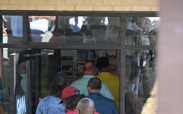 Military personnel and civilians queue to enter new MWR facility