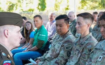 82nd Airborne Division Staff Sergeant Presents Folded Flag to Military Police Soldiers During Ceremony