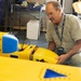 Technician Performs Maintenance on Yellow Unmanned Surface Vessel
