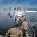 U.S. Air Force personnel from the 911th Airlift Wing are applying or unveiling nose art on a military transport aircraft (tail number 0601). The nose art reads 'The Spirit of Roberto Clemente,' honoring the legendary Pittsburgh Pirates baseball player. The ceremony appears to be taking place on a flight line during daylight hours.