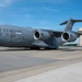 A U.S. Air Force C-17 Globemaster III military transport aircraft, tail number 0601, assigned to the 911th Airlift Wing, is parked on a tarmac at an Air Force Reserve installation. The aircraft bears a special nose art dedication reading 'Roberto Clemente.' A water tower labeled 'Air Force Reserve' is visible in the background.