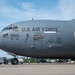 A U.S. Air Force C-17 Globemaster III military transport aircraft is parked on a tarmac. The aircraft bears the nose art designation 'The Spirit of Roberto Clemente' along with tail number 0601 and unit marking 911th AW (Airlift Wing). Ground support equipment and vehicles are visible in the background.