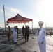 Sailors stand at ease aboard USS Russell (DDG 59) during pier-side ceremony