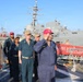 U.S. Navy sailors render honors aboard USS Russell (DDG-59) during pier-side ceremony