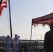 U.S. Navy Chief Selectees and service member render honors during colors ceremony aboard naval vessel