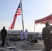 Sailors render honors during colors ceremony aboard USS RUSSELL