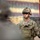 U.S. Soldier stands ready during Yudh Abhyas 2026 A U.S. Army soldier in full combat gear stands at attention during what appears to be a formal military ceremony or formation. The soldier wears Operational Camouflage Pattern (OCP) uniform with a tactical helmet, body armor, and rank insignia visible on the chest plate indicating the rank of Staff Sergeant. A red guidon flag with gold crossed cannons (Field Artillery branch insignia) is visible in the background.